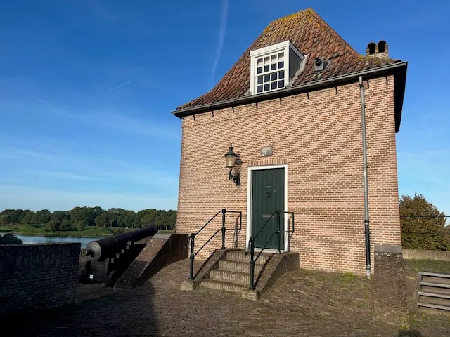 Het poorthuisje boven op de Wijkse Poort, met de groene voordeur en een trap